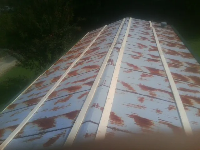 Rusted metal roof panels with new wood purlins before replacement — Storm Damage Roof Repair in Janesville by Roofing Brothers