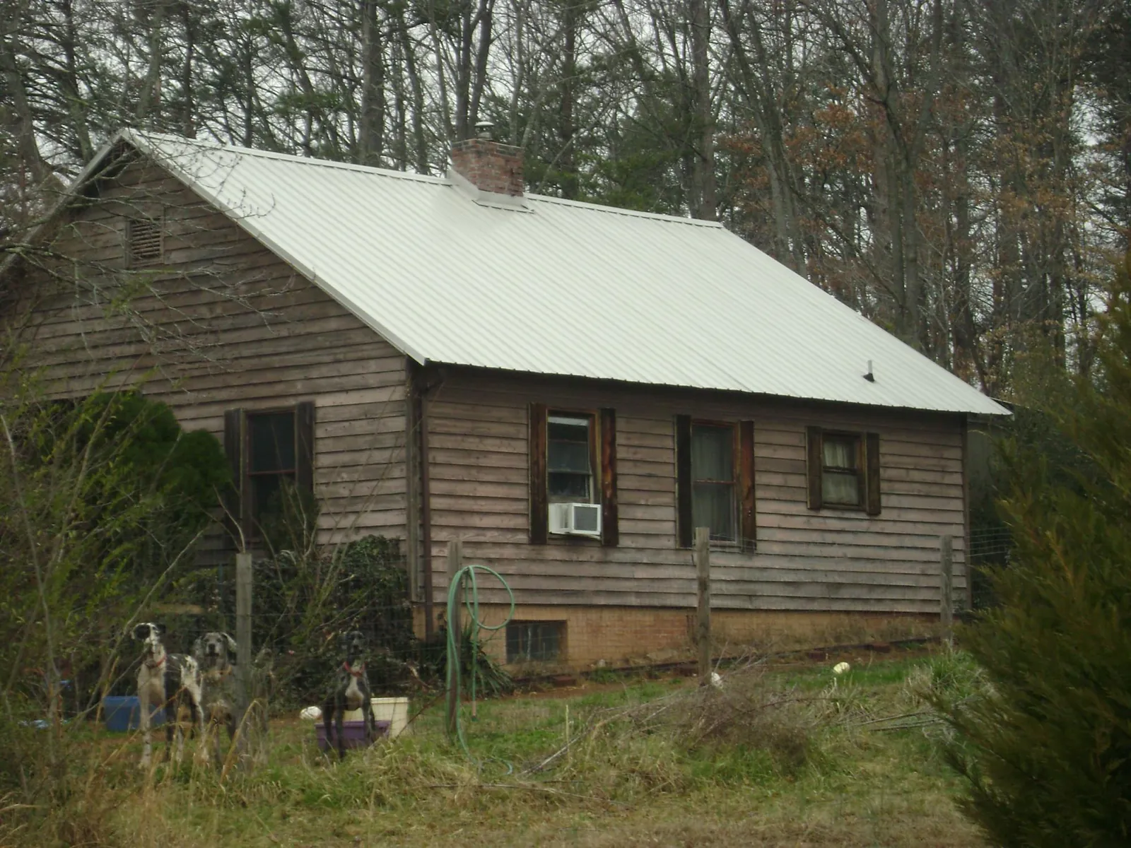 White metal roof on an old wood sided farmhouse, from a Metal Roof Installation job in Janesville